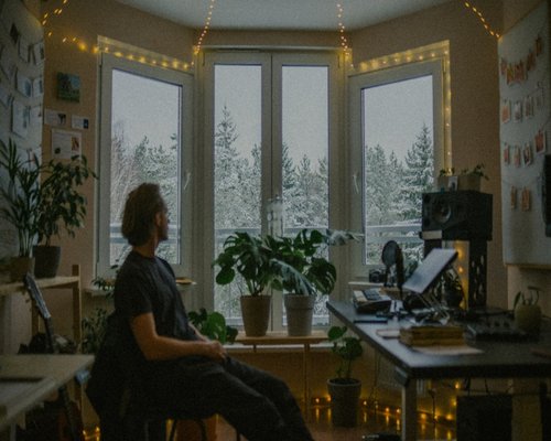 Person typing on laptop in an urban apartment
